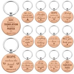 twelve wooden keychains with bible verses on the front and back, each engraved with