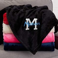 towels stacked on top of each other with the word mandel written on them in blue