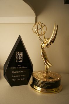 an award sitting on top of a table next to a trophy