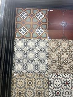 several different types of tile on display in a window sill, with the same pattern and color as well