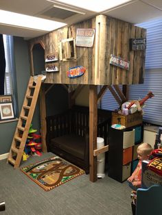 a child's bedroom with a wooden loft bed and ladder to the top floor