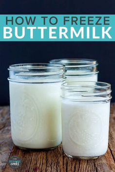 three jars filled with buttermilk sitting on top of a wooden table next to each other