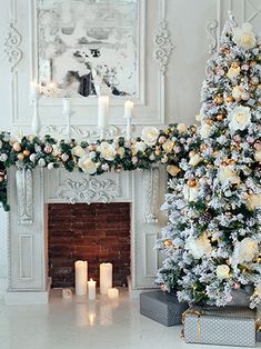 a decorated christmas tree sitting in front of a fire place with candles on the mantle