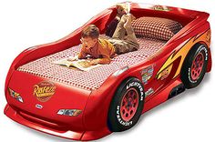 a child's bed with a red race car theme