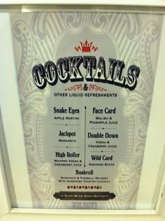 an advertisement for cocktails on display in a white frame with black lettering and ornate designs