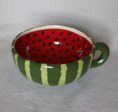 a green and red bowl with watermelon on it