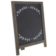 a chalkboard with a wreath drawn on the front and bottom, standing upright against a white background