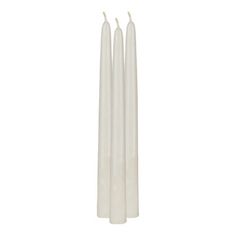 three white candles sitting next to each other