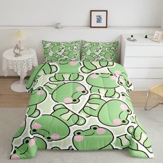 a bed with green frog print on it