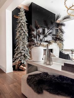 a living room filled with furniture and christmas trees