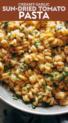 sun dried tomato pasta in a bowl with parsley on top and text overlay that reads, creamy garlic sun dried tomato pasta