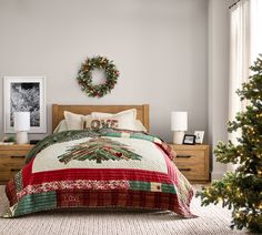 a bedroom decorated for christmas with a wreath on the wall