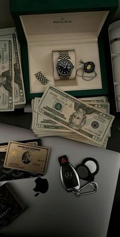 an apple computer sitting on top of a desk next to money