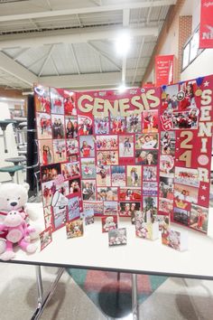 a table topped with lots of pictures and a teddy bear sitting on top of it