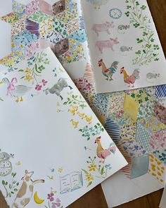 several different colored papers with animals and flowers on them