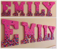 two pink letters with sprinkles are hanging on the wall