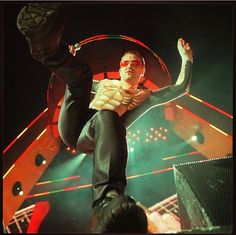 a man is doing tricks on his skateboard in front of the crowd at a concert