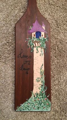 a wooden sign with a lighthouse painted on it's side and the words, love is