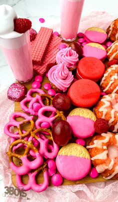 there are many different types of donuts on the tray and one is pink with white icing