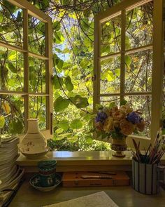 an open window in a room filled with lots of green plants and flowers on the windowsill