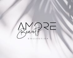 the logo for amore beauty collection is shown in black on a white background with shadows