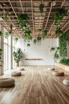 an empty room with wooden floors and plants hanging from the rafters on the ceiling