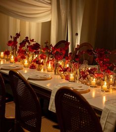 a long table is set with candles and flowers for a formal dinner or party event