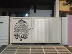 a white gate with a tree on it