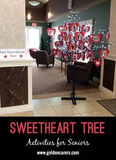 there is a heart tree in the middle of this lobby with pictures on it and words that say, sweetheart tree activities for seniors