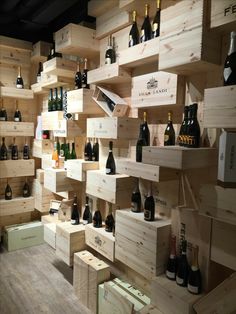 several wooden shelves with wine bottles on them