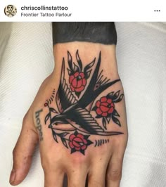 a person's hand with a bird and flowers tattoo on the left side of their palm