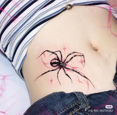 a woman with a spider tattoo on her stomach