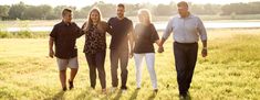 a group of people standing next to each other in a field