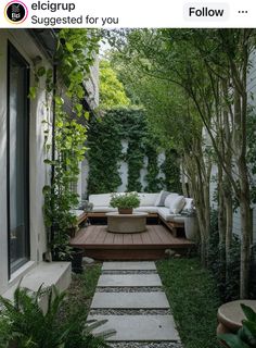 an outdoor living area with wooden steps leading up to a couch on the side of it