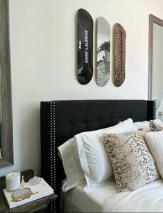 a bedroom with skateboards mounted on the wall above the headboard and pillows in front of it