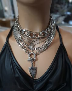 This handmade chunky stainless steel chain layered necklace set is a stunning piece of jewelry that is perfect for those who love bold and edgy accessories. This is two necklaces, the big chunky choker that is adjustable with a built-in extender, and the 4-strand drop festoon design necklace (also adjustable). Adding depth and dimension to the piece is a u lock and arrowhead pendant. Very punk, grunge aesthetic! All the chains are made of sturdy stainless steel, ensuring durability and longevity, and making it completely hypoallergenic, waterproof, and non tarnish. It will look exactly like this forever!  This necklace set is an excellent handmade gift for someone special. It is a perfect choice for those who love alternative and goth styles, as well as anyone who wants to make a statement Goth Layered Necklaces, Chunky Chain Link Necklace Gift, Trendy Multi-strand Chunky Chain Jewelry, Trendy Chunky Necklace, Trendy Chunky Necklaces As A Gift, Trendy Chunky Necklaces As Gifts, Trendy Chunky Necklace As Gift, Trendy Chunky Necklace For Gift, Trendy Silver Tarnish-resistant Chain Necklace