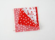 two red and white napkins with christmas trees on them