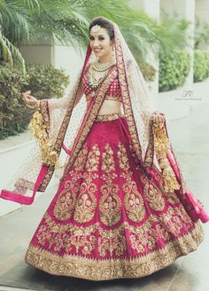 a woman in a red and gold bridal gown