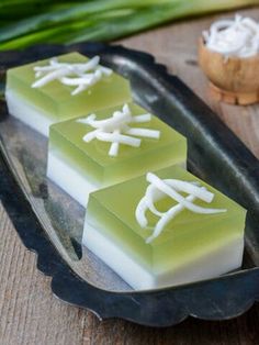 three pieces of soap sitting on top of a metal tray