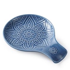 a blue dish with an intricate design on it