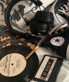 an old fashioned record and some other items on a bed