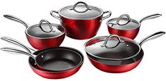 a set of red pots and pans with lids