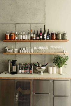 the bar is full of bottles and glasses on it's shelfs, along with other items