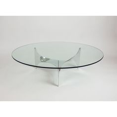 an oval glass table with metal legs