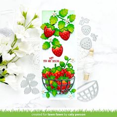 a card with strawberries and flowers on it