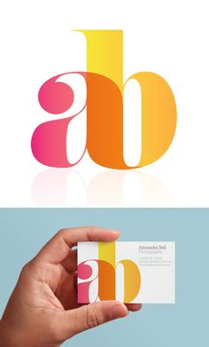 a hand holding up a business card with the letter b on it and an image of a