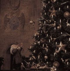 a christmas tree in front of a decorated wall