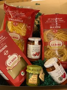 a box filled with pasta and sauces on top of a table