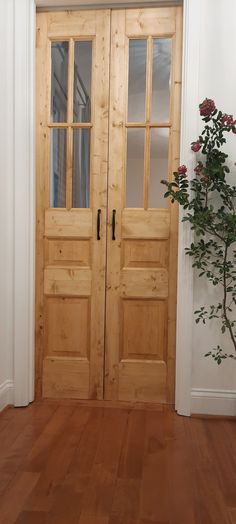 two wooden doors in a room with wood floors