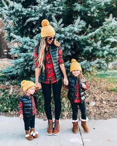 a woman and two children wearing winter clothes